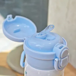 Detailed close-up view of light blue insulated vacuum water bottle with pop-up straw lid