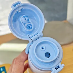 Stainless steel vacuum water bottle lid detail showing dual drinking straw and sip mechanism.