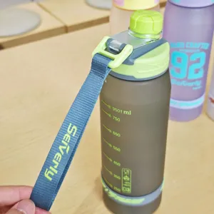 Detailed view of frosted plastic sports water bottle with handy strap and capacity scale.