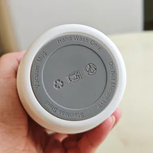 Stainless steel vacuum coffee mug bottom detail, portable insulated travel cup display.