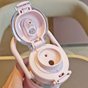 Stainless steel dual-drink vacuum water bottle lid detail showing straw and direct ports.