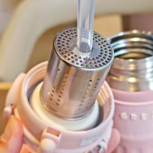 Detailed view of stainless steel thermos cup with straw and filter, portable vacuum design.