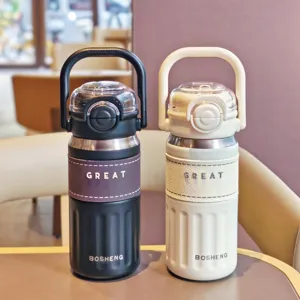 Stainless steel dual-drink vacuum insulated water bottle with straw and portable handle, detail shot