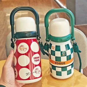 Portable stainless steel vacuum insulated water bottle with handle and strap, stylish design.