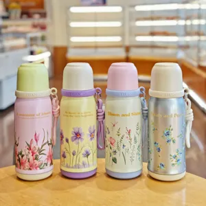 Detail shot of four colorful insulated water bottles with floral prints and portable straps.