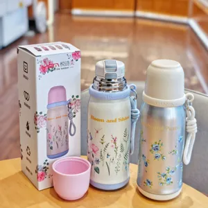Stainless steel floral vacuum thermal flask portable water bottle with cup and strap design.