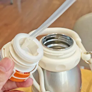 Detailed view of the stainless steel vacuum water bottle straw lid and inner lining.