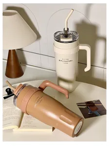 Large capacity stainless steel insulated tumbler cup with straw and handle for daily travel use.