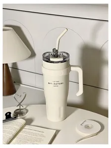 Minimalist stainless steel insulated tumbler with handle and straw, large capacity travel mug.