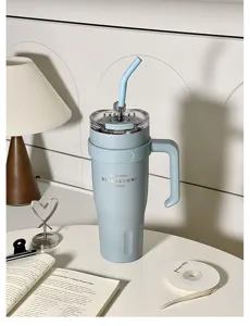 Light blue stainless steel tumbler with handle, straw and large capacity for daily use.