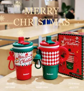 Christmas insulated straw cup detail showing handle design, vibrant red and green holiday colors.