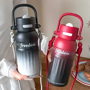 Gradient stainless steel vacuum insulated water bottle with straw lid, strap and handle.