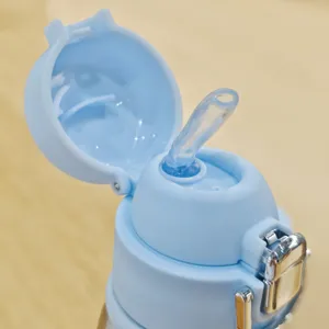 Gros plan détaillé du couvercle de tasse isotherme bleu clair avec paille et fermoir métallique.