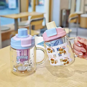 Detail shot of cute borosilicate glass straw cup with handle and playful puppy pattern.