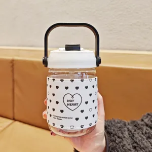 Clear plastic water bottle detail, featuring a white leather sleeve with black heart patterns.