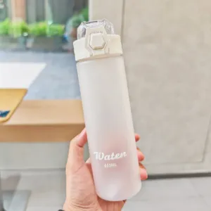 Detailed close-up view of a frosted plastic sports water bottle held securely in hand.