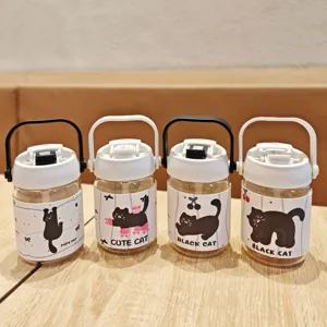 Portable glass water bottle with cute black cat leather sleeve, portable handle and straw.