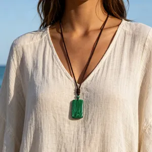 Detailed close-up view of a retro rectangular malachite pendant necklace on model.