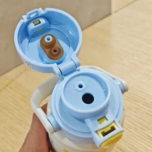Kids insulated water bottle with dual-drink straw design, stainless steel vacuum flask.