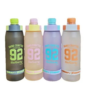 Large capacity frosted plastic sports water bottle with straw, portable strap and stylish design.