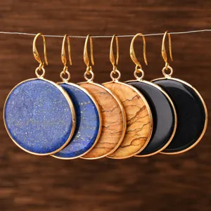 Detailed close-up view of elegant round natural stone gold-plated drop earrings hanging neatly.