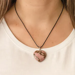 Detail shot of heart pink crystal pendant necklace on black cord for women daily wear