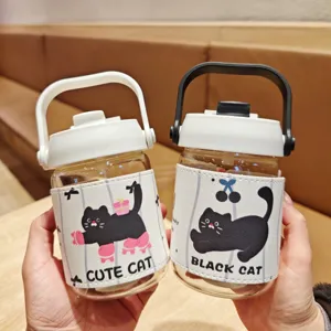 Detailed view of cute black cat glass water bottle with protective leather sleeve and straw.