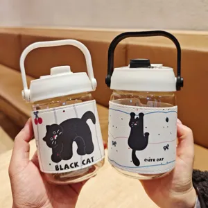 Detailed view of cute black cat glass water bottles with leather sleeves and convenient handles.