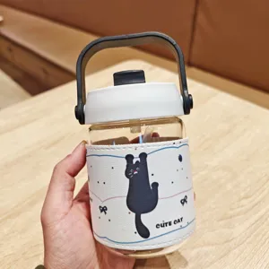 Cute cat glass water bottle with portable handle, straw, and protective leather sleeve.