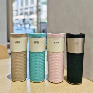 Stylish minimalist stainless steel coffee mug with silicone sleeve, vacuum insulated cup.