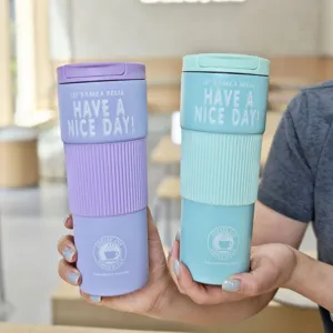 Stainless steel travel coffee mug detail showing colorful silicone grip sleeve and vacuum insulation.