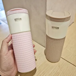 Stainless steel coffee vacuum mug with silicone sleeve, couple insulated water bottle detail.