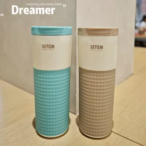 Stainless steel insulated coffee mug with waffle silicone sleeve, detailed view of travel tumbler.