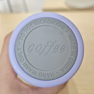 Stainless steel coffee cup detail view featuring clear product care instructions and silicone.