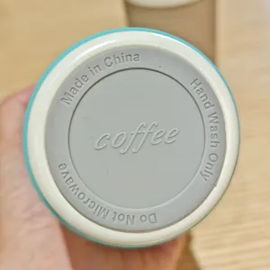 Stainless steel coffee tumbler bottom detail view, silicone protective base care label.