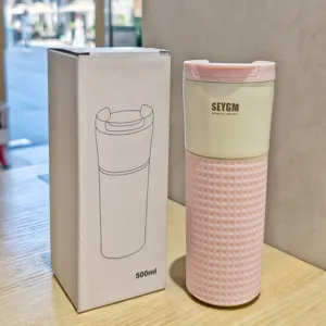 Stainless steel vacuum coffee cup with pink silicone sleeve, 500ml insulated travel mug.