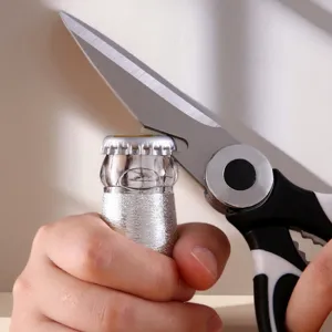 Multifunctional kitchen scissors detail showing bottle opener feature and stainless steel blade.
