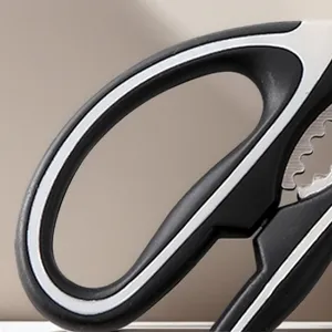 Close-up detail of multi-functional kitchen scissors with ergonomic black and white handle.