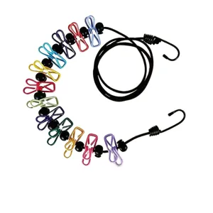 Close-up detail of travel clothesline featuring colorful clips and hooks for outdoor drying.