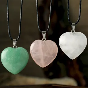 Heart shaped gemstone pendant necklace detail view and gemstone charm collection.