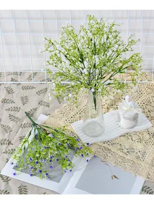 Artificial baby breath flowers detail shot, single branch faux gypsophila for wedding decor.