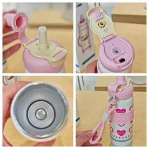 Cartoon stainless steel dual-drink insulated thermos bottle with straw and portable strap.