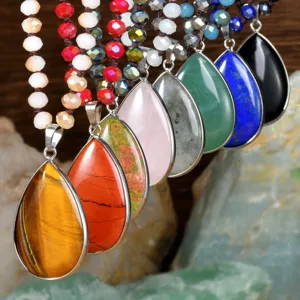 Bohemian teardrop natural stone pendant necklace detail, crystal beaded sweater chain closeup.