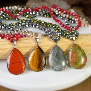 Close-up of bohemian teardrop natural stone pendant necklace with multi-layer crystal beads.