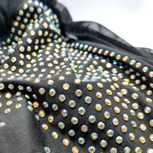 Rhinestone mesh dress detail, sexy clubwear fabric close-up with sparkling crystals.