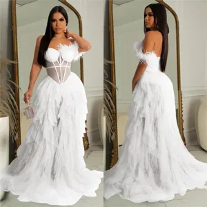 Detailed view of white strapless corset long dress with feather and tulle layers for women.