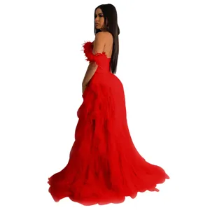 Red strapless evening dress detail, feather sleeve accents, flowing layered tulle skirt view.