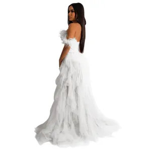 Detailed view of the white strapless tulle long dress with delicate feather decor and layered skirt.