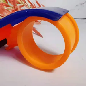 Πλαστικός dispenser ταινίας συσκευασίας για κουτιά αποστολής, πορτοκαλί και μπλε.