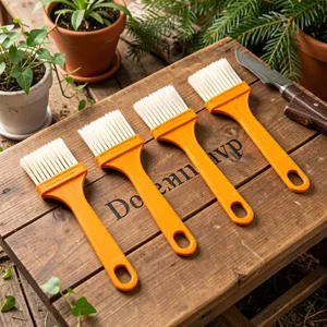 Set of four yellow plastic pastry brushes with white bristles for baking, BBQ, and cooking.